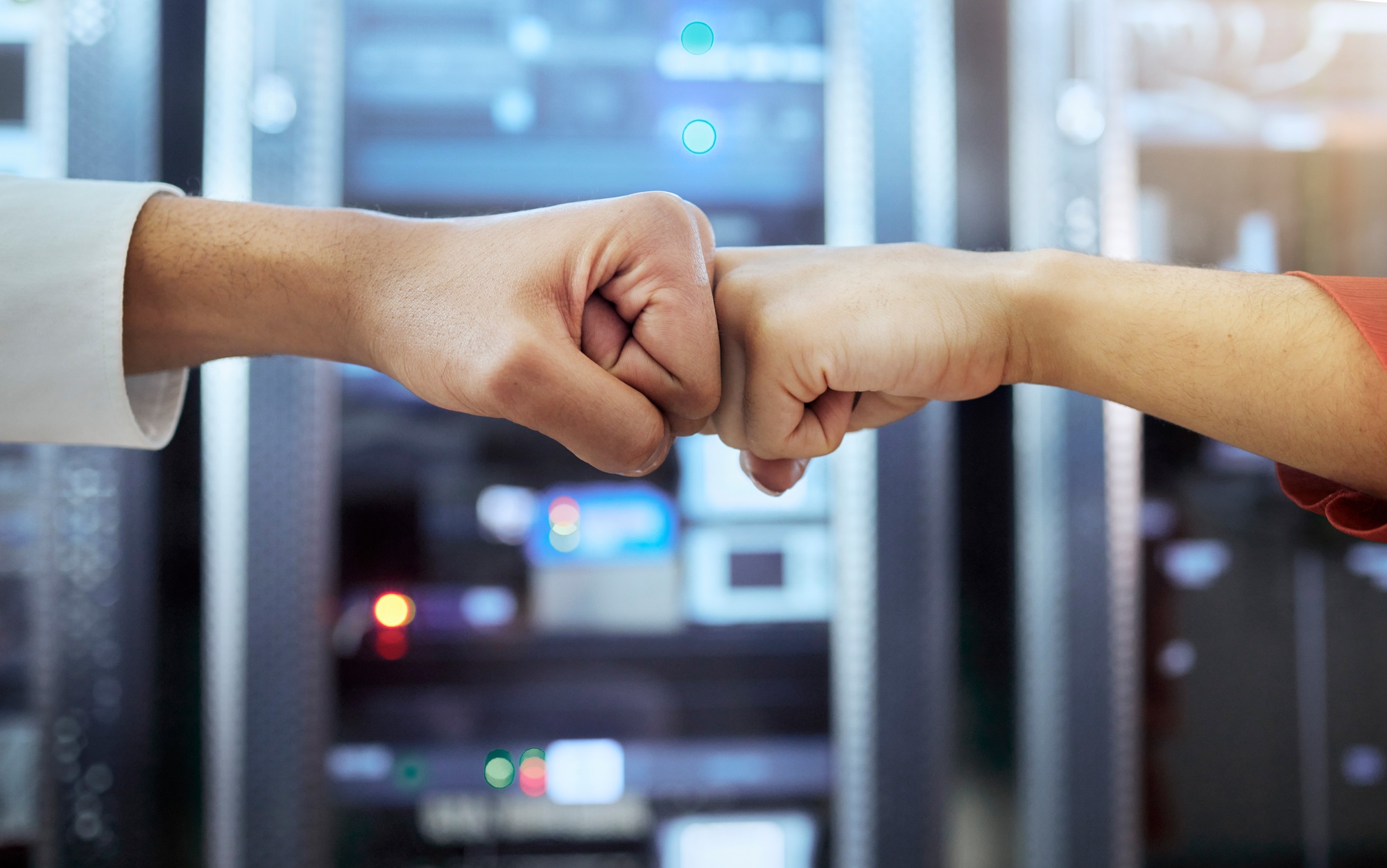 Fist bump, coding teamwork and programming server room of cyber data security storage, coding netwo